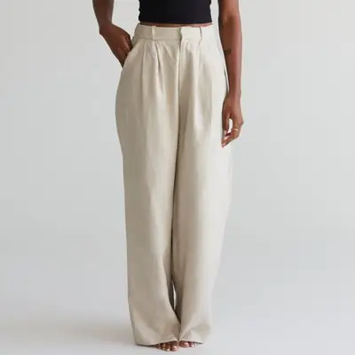 Re Ona Toni Linen Trousers in light wash natural on model styled with black top
