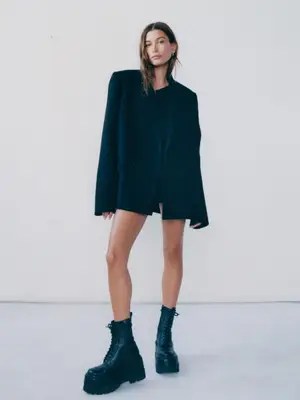 Hailey Bieber wears an all-black outfit featuring an oversized blazer and black combat boots