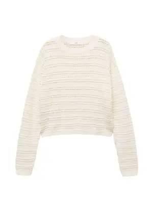cream sweater with open knit pattern