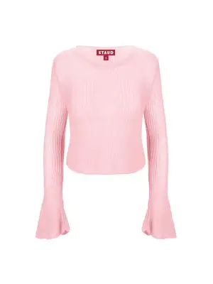 Suki Waterhouse wearing a textured, asymmetrical sweater with cross pattern