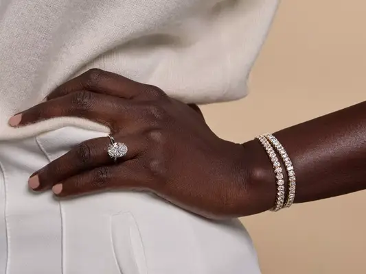 Close-up of hand with lab-grown diamond ring and bracelets