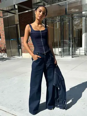 Yara Shahidi wears a denim corset top, jeans, and jacket