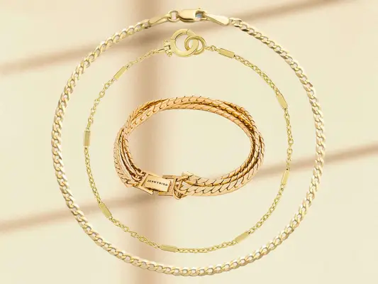 Three of our favorite bracelets from brands Brilliant Earth, Gorjana and Jenny Bird on a neutral background