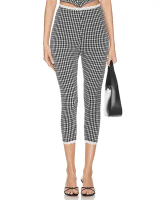 model wearing black and white gingham capris
