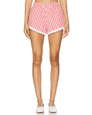 model wearing red and white gingham shorts
