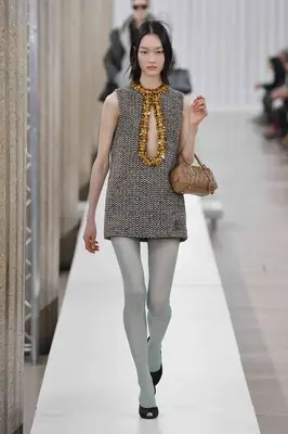  model walks the Miu Miu Ready to Wear Fall/Winter 2023-2024 show wearing colorful tights