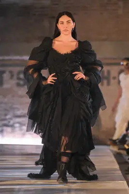 Yumi Nu wears a black voluminous gown on the Collina Strada fall 2025 runway