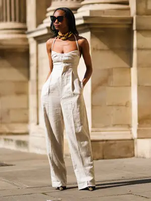 Model wearing a short white linen dress 