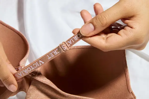 Hands hold a strap on the Victoriaâs Secret Push-Up Perfect Shape Bra