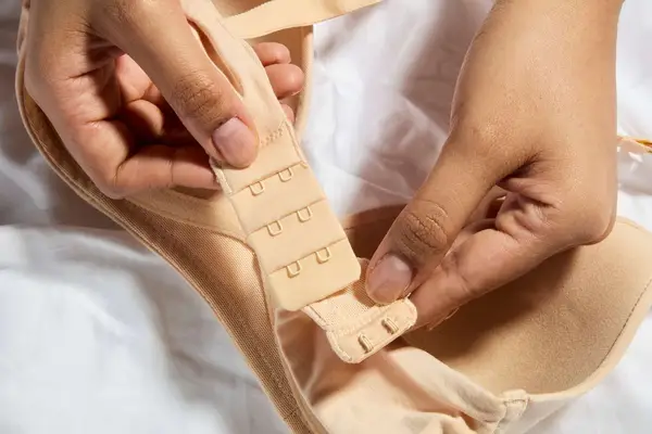 Hands hold the hooks on a Lively All-Day Plunge No-Wire Bra