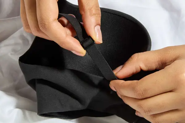 Hands hold the strap on a Skims Fits Everybody Push-Up Bra