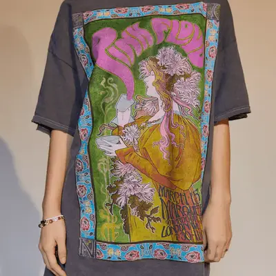 Doc Martens shearling-lined chelsea boots with purple knit socks and an orange plaid skirt