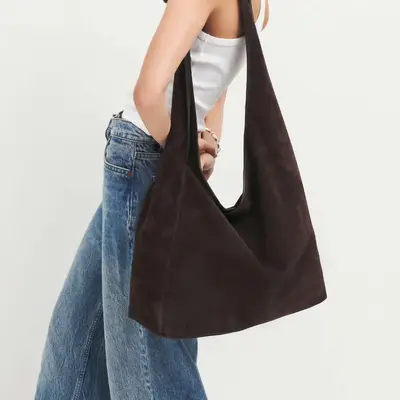 Reformation Oversized Vittoria Tote bag in black on model wearing white tank top and jeans