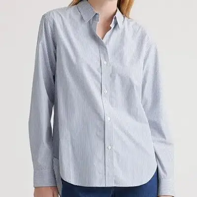 A model is wearing a white tank top 