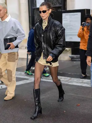bella hadid wearing black leather bomber jacket and black square toe boots