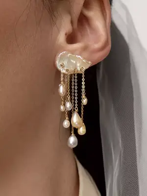 Close-up of woman with colorful pearl cloud and droplet earring
