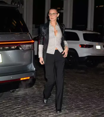 Bella Hadid wearing a gray button down and 