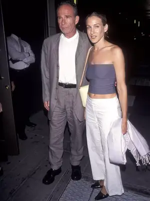 Sarah Jessica Parker wearing a gray tube top with white pants and black pointed-toe shoes