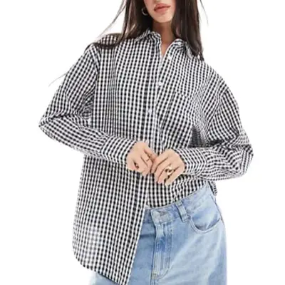 person wearing a gingham shirt
