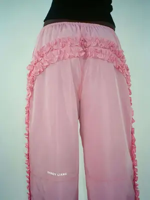 model wearing pink pants with ruffles on the back and sides