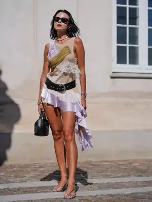 Woman wearing bohemian mini dress with lace and satin details