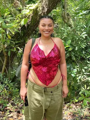 Bella Golden wears a black woven cowboy hat and strappy black dress at Coachella