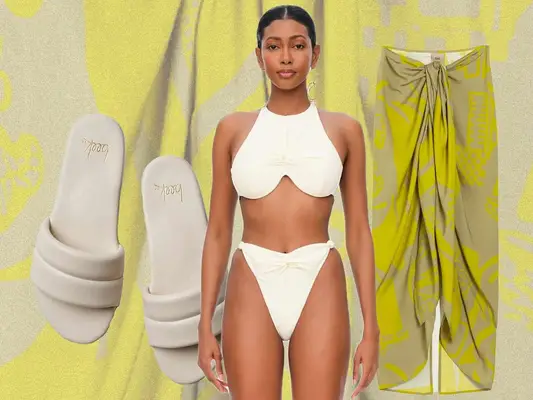 Off-white padded sandals, white two-piece swimsuit on model, and green and beige patterned sarong