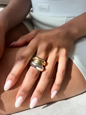 Close-up of hand wearing gold and silver rings