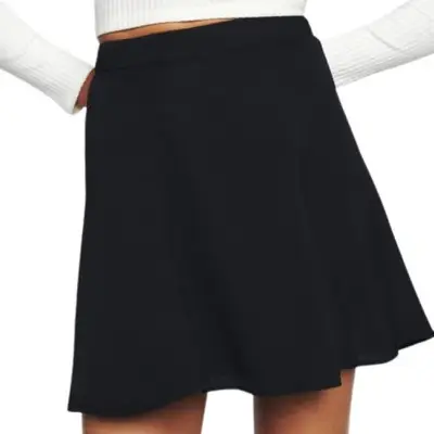 Reformation Flounce Skirt in black mini length on model styled with white ribbed top