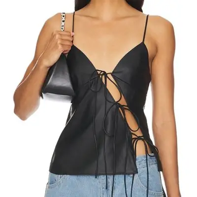 Lioness Mariah Cami black tie tank top on model styled with shoulder bag and light wash denim