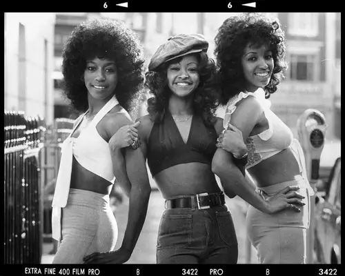 Three women wearing crop tops in the 1970s