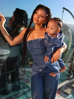 Halle Bailey wearing denim strapless tube top and jeans