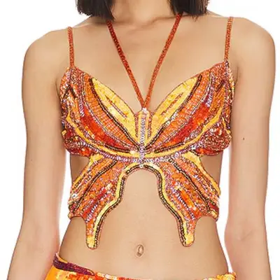 model wearing orange and yellow sparkle butterfly top