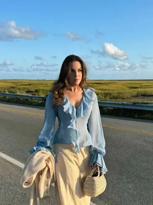 Avec Les Filles Long Trench Coat in neutral with plaid lining on model styled with black buttoned mini dress