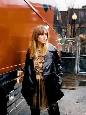 Suki Waterhouse wears a crocheted fringe top, leather jacket and pants