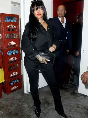 Rihanna wears a black denim outfit with black accessories