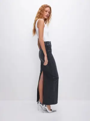 Model wearing a white tank top, a black denim maxi skirt, and silver metallic heels