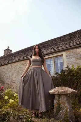 Kacey Musgraves wearing a skirt and top from her Reformation collection