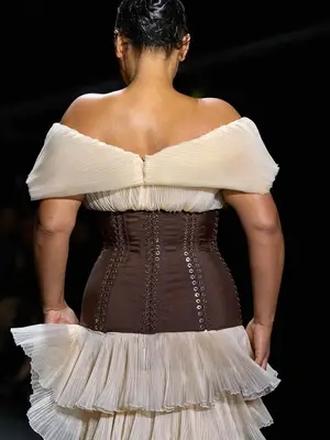Back view of Paloma Elsesser wearing corseted gown with tiered ruffles