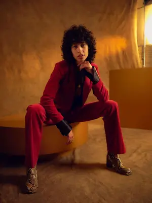 Towa Bird wears a red velvet suit and snakeskin boots