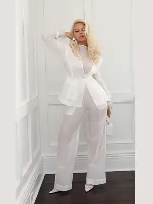 Woman wearing white flowing dress with cinched waist