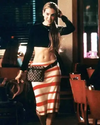 Carrie Bradshaw wearing a cropped black long sleeve top with a red and white striped skirt and a Gucci belt bag