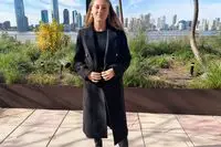 A person outside while wearing the Babaton The Constant Coat