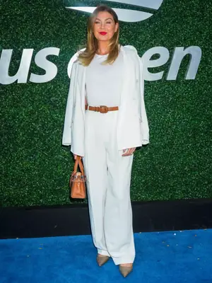 Ellen Pompeo at the 2023 US Open wearing a white three-piece suit.