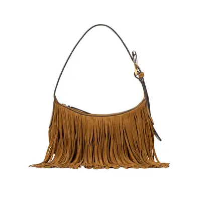 Poppy Delevingne wearing all white outfit holding tan suede handbag