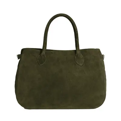 Close-up of woman wearing butter yellow jacket, floral tie pants, and brown suede handbag