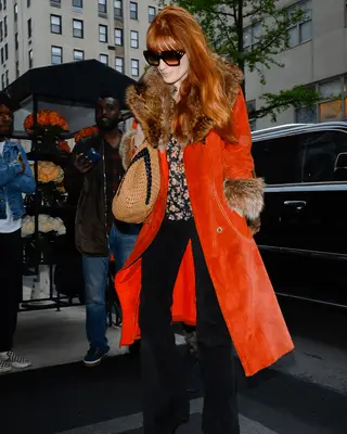 Florence Welch wearing an orange Penny Lane coat