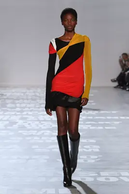 Model wearing a pink, yellow, black, and white color-blocked dress at the Peter Do for Helmut Lang Spring 2024 show
