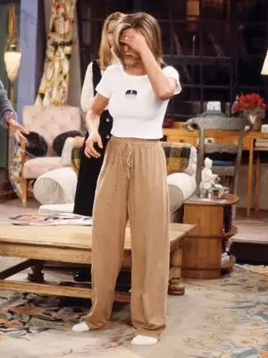 Jennifer Aniston wearing a baby tee and beige drawstring pants on Friends