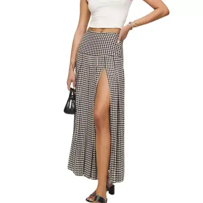 Reformation pleated skirt with slit on model